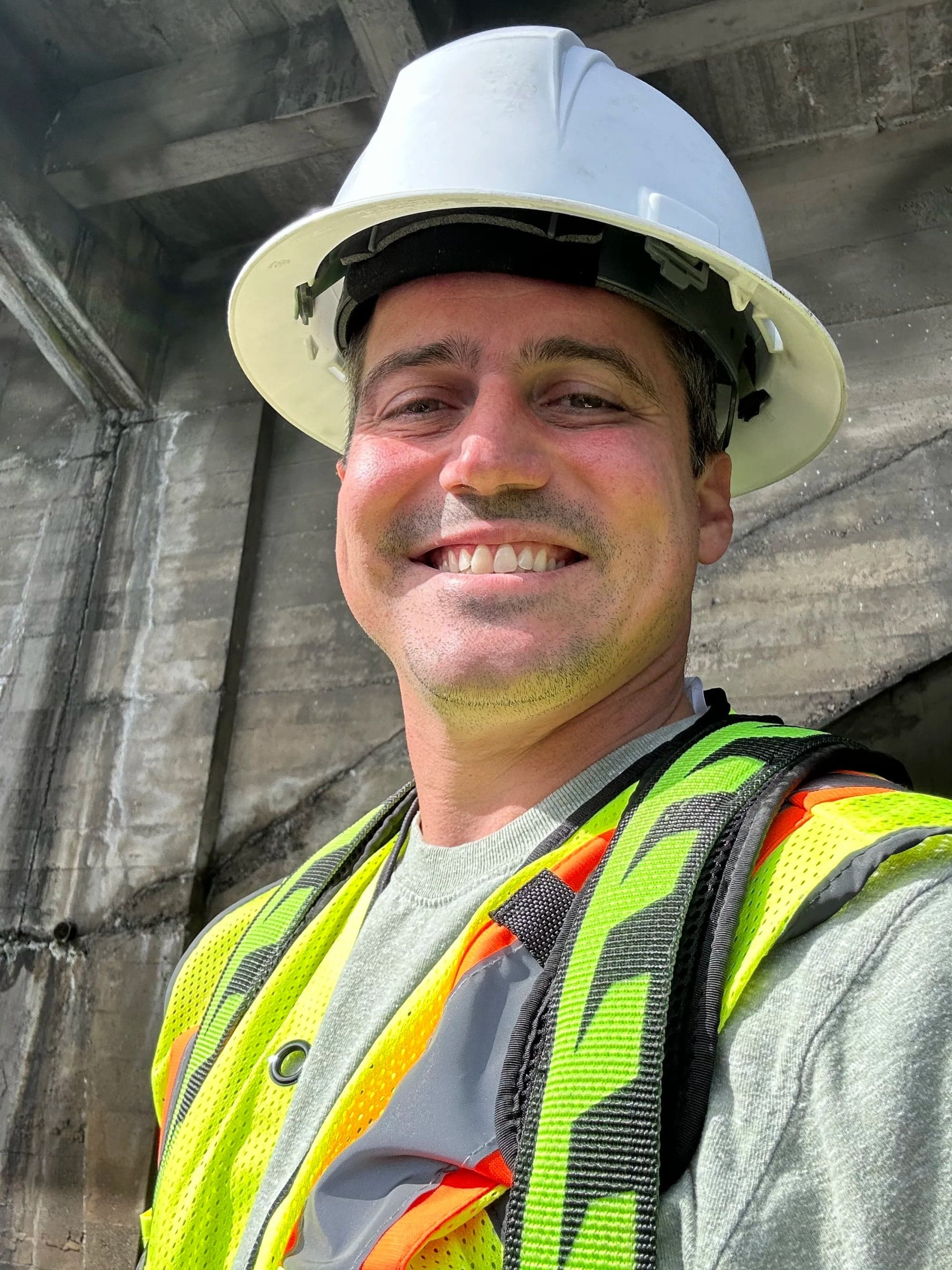 Jonathan in a hard hat on a job site